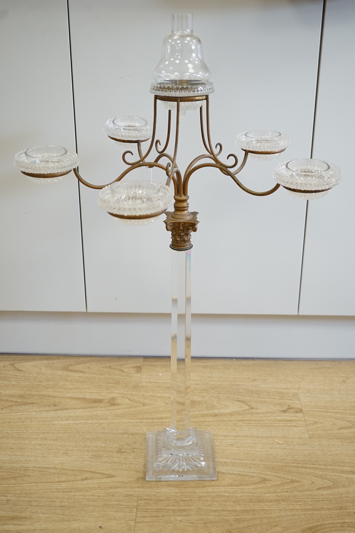 A Victorian glass and brass Corinthian column five branch, six light epergne centrepiece, 83.5cm high. Condition - slight chip to one corner of the base and funnel to top light chipped